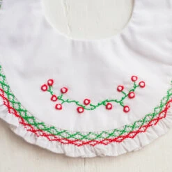 Smocked Ruffle Holiday Bib -Baby Clothing Store Photo Jan 11 3 41 46 PM 36941.1638807083